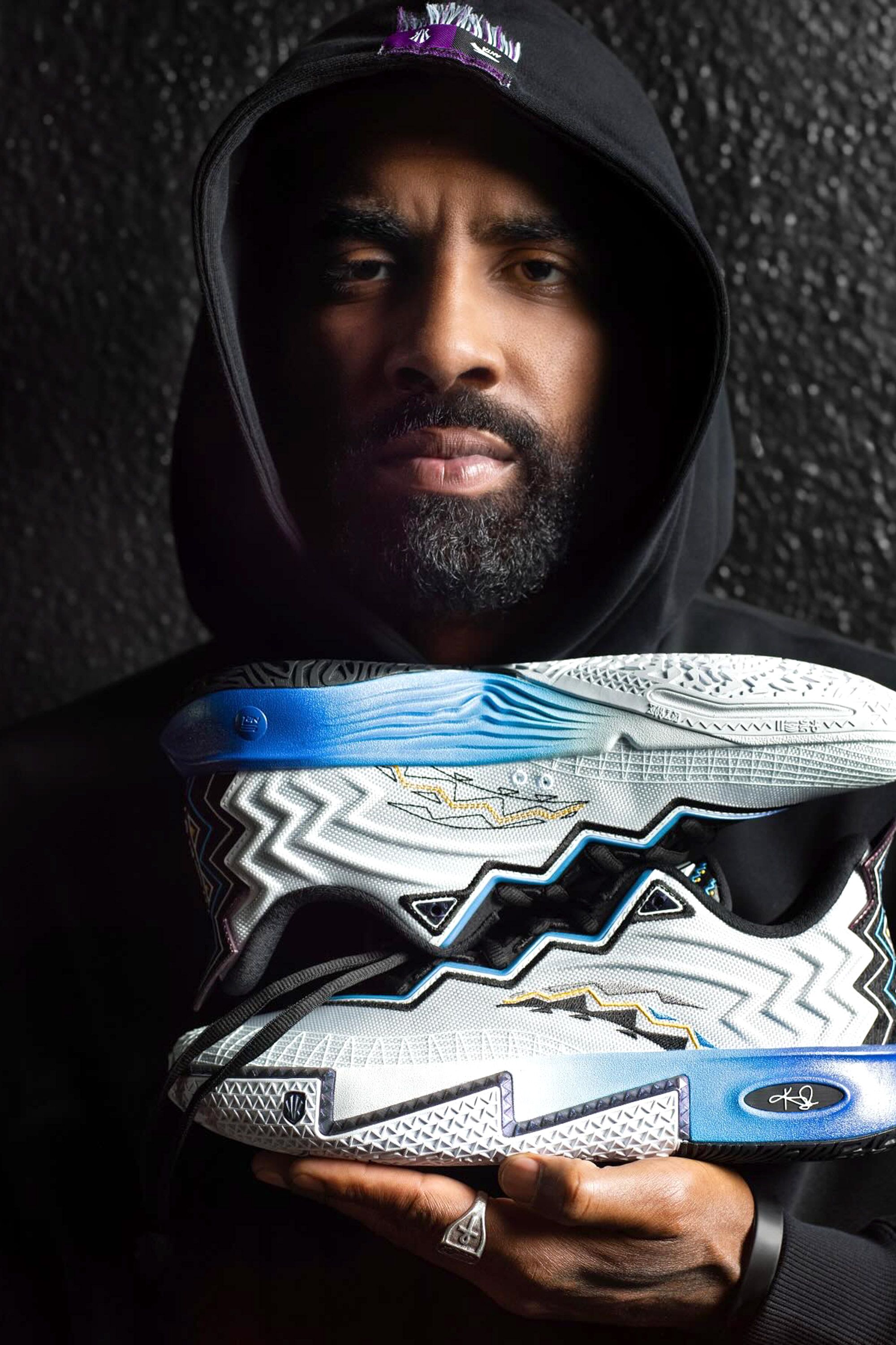 Image may contain Kyrie Irving Clothing Footwear Shoe Sneaker Face Head Person Photography Portrait and Adult